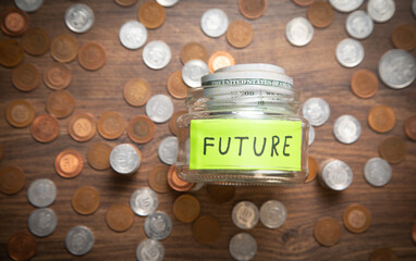Jar of coins and word Future. Concept of saving money for future