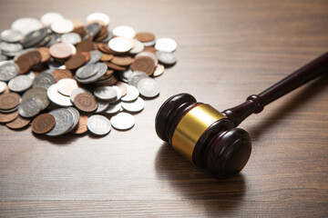 Stack of coins with judge gavel.