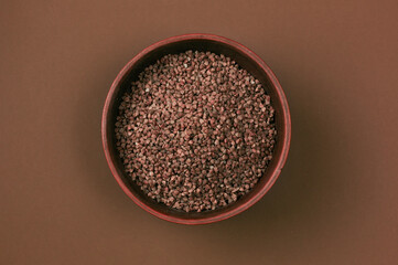 Cereals. Rice. buckwheat, oatmeal, wheat. Various types of cereals in bowls on a brown background. Healthy food. Various cereals.