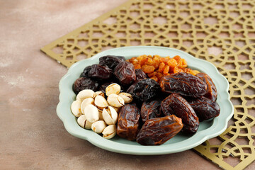 Various Snack for Sweet Takjil Iftar Moslem Ramadan Month, Pistachio, Dates Fruit, and Golden Raisin.