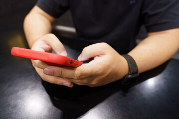 Man playing game on mobile phone. gamer boy playing video games holding Smartphone working mobile devices. cell telephone technology e-commerce concept.