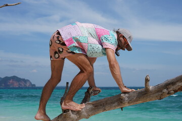 portrait of a man on the beach in krabi thailand with sunglasses, poda island, model shooting 