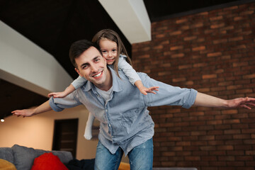 Happy loving family. Father and his daughter child girl play together, make an airplane. Father's day concept