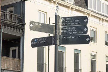 Pole with a blue signpost in the center of Arnhem in the Netherlands