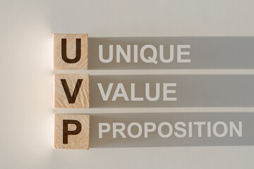 Wooden cubes building word UVP - abbreviation Unique Value Proposition on light background.