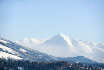 Fototapeta na wymiar Symbol of Slovakia - peak Krivan from Haj-Nicovo near Liptovsky Mikulas in winter with snow. Slovakia, Liptov region. Snowy mountains.