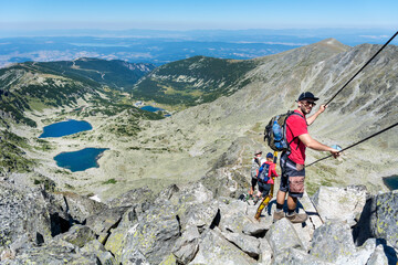 Young man hiking in the summer mountain in Bulgaria  .Rila Mountain, Musala peak 