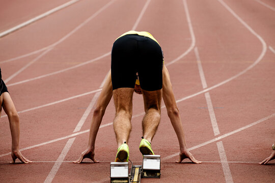 runners sprinters in starting blocks on SET command