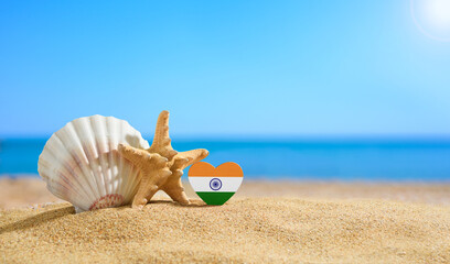 Fototapeta na wymiar Beautiful beach in India. Flag of India in the shape of a heart and shells on a sandy beach.