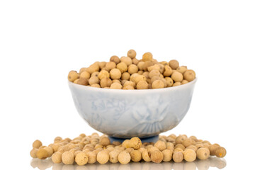 Fragrant vegetable coriander seeds in  ceramic plate, macro, isolated on white background.