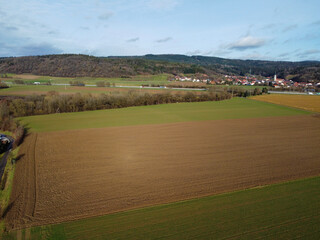 Aerial view of a green agricultural field and a cloudy day.