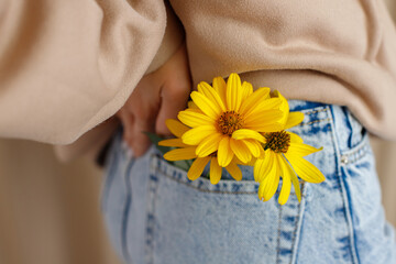 yellow flowers in jeans pocket