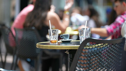 Restaurant leftovers in exterior empty table with cups and straws