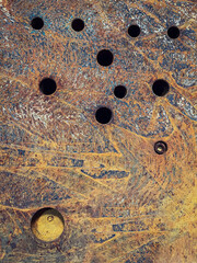 steel plate with some holes completely rusted, rust texture, red rust process, corrosion, vertical