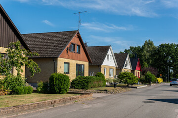 Fototapeta na wymiar Sweden, Knislinge – July 30, 2022: Beautiful private houses along the street on a sunny summer day. European architecture, modern village. Cottage house, dacha. Cozy place for living. Real estate. 