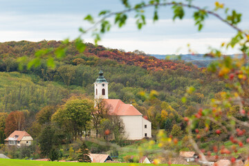church in the middle of a village among colorful hills