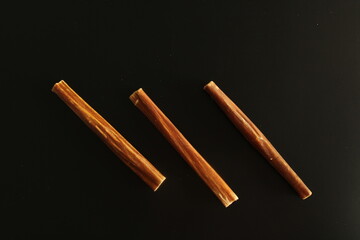 Dehydrated ox esophagus in a black background. Dog treats.