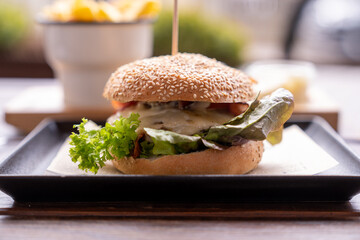 Burger with cheese, lettuce and becon. Taken with depth of field