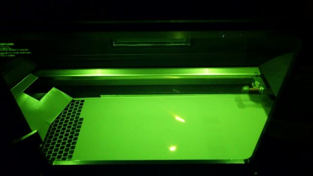 Working 3d printer for metal. 3D printer printing object from metal powder in working chamber by sintering metal powder under laser. SLM. Selective laser melting technology. Melting metal powder