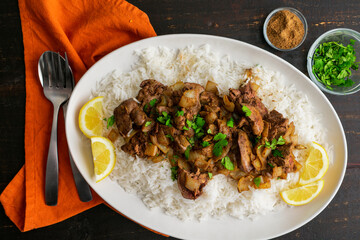 Curried Chicken Livers Served Over Basmati Rice: Chicken livers cooked in Indian spices served with cilantro, lemon, and garam masala