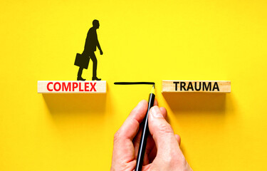 Complex trauma symbol. Concept words Complex trauma on wooden block. Beautiful yellow table yellow...