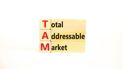 TAM total addressable market symbol. Concept words TAM total addressable market on wooden blocks on a beautiful white table white background. Business TAM total addressable market concept. Copy space.
