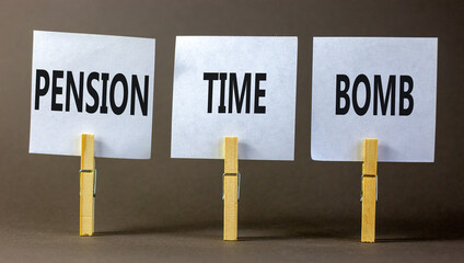 Pension time bomb symbol. Concept words Pension time bomb on white paper on clothespin on a beautiful grey table grey background. Business pension time bomb concept. Copy space.
