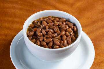 Brazilian beans garnish on wooden table.