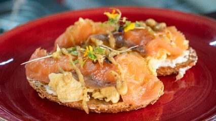 a close up image of smoked salmon and scrambled eggs on toast garnished with edible flowers 