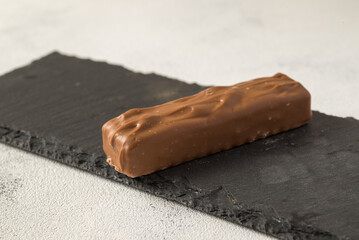 Chocolate stick on tray and white table