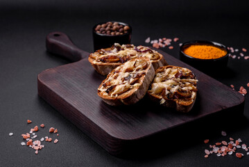 Delicious crispy toast or bruschetta with fried onion, champignon mushrooms and cheese
