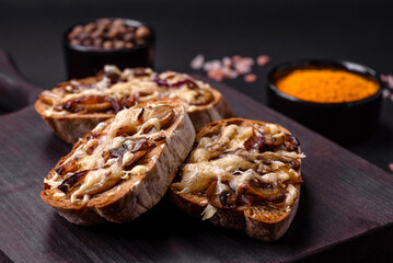 Delicious crispy toast or bruschetta with fried onion, champignon mushrooms and cheese