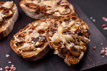 Delicious crispy toast or bruschetta with fried onion, champignon mushrooms and cheese