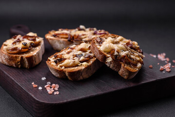 Delicious crispy toast or bruschetta with fried onion, champignon mushrooms and cheese