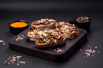 Delicious crispy toast or bruschetta with fried onion, champignon mushrooms and cheese
