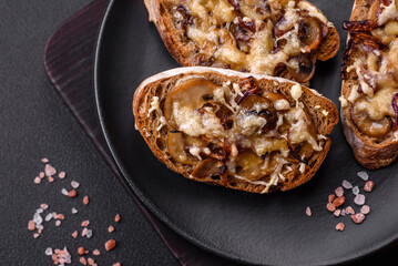 Delicious crispy toast or bruschetta with fried onion, champignon mushrooms and cheese