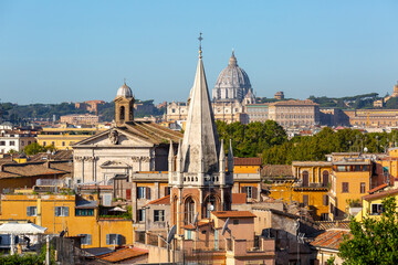 Aerial view of the city with Saint Peter's Basilica in Vatican City in the distance and  and tower of All Saints' Church, Rome, Italy