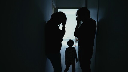 Silhouette of couple standing in corridor in crisis. Parents with child feeling worry and anxiety....