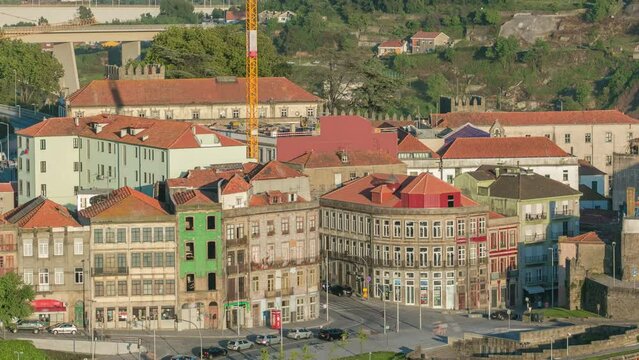 Street Avenida Dom Afonso Henriques - aerial view from Clerigos Tower viewpoint in Porto timelapse before sunset, Portugal. Traffic on intersection