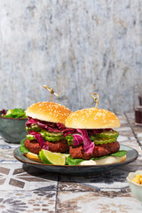 beetroot burger with lettuce and cucumber on marble background