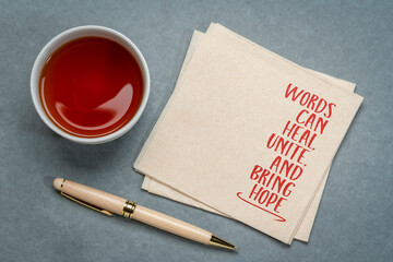 Words can heal, unite, and bring hope. Inspirational handwriting on a napkin, power of words and communication concept.