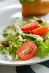 red cherry tomato and lettuce on a plate 