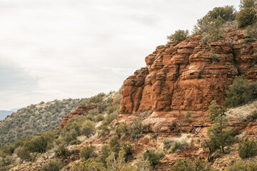 Young female woman walking on popular hiking trail in Sedona Arizona during the day on the famous Airport mesa loop hike near Vortex in Oak Creek area