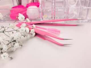 Staff for eyelash extensions in beauty salon, pink equipment for beauticians