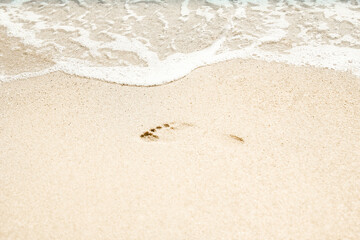 Fototapeta na wymiar A Beautiful sea and sand on the shore vacation travel background