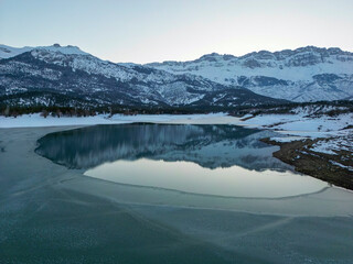 Fototapeta na wymiar sunset time on frozen lake, wonderful nature and amazing mountains