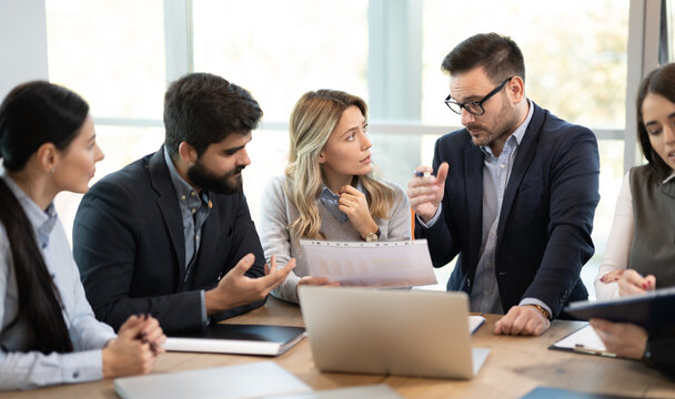 Business boss and manager discussing paper document at meeting in office