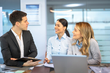 Three business partners talking in a meeting at office.