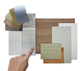 architect selecting interior material samples including oak veneer, douglas fir veneer, oak laminated and grey fabric laminateds isolated on background with clipping path. hand choosing materials.