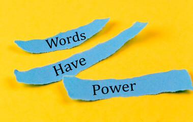 WORDS HAVE POWER text on a blue pieces of paper on yellow background, business concept